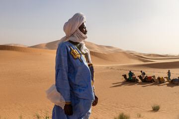 Camel trek through the Sahara desert dunes in Morocco