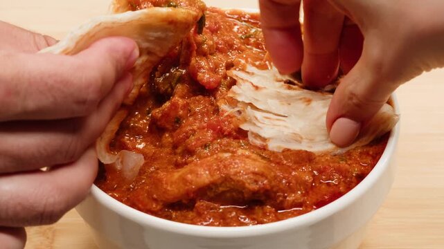 Cooking chicken Indian curry, tikka masala, chicken, lamb, mutton Rogan Josh grill boiling on pan, sauce. Dark background. Close up.