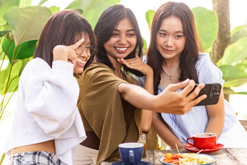 Asian teenagers enjoying in an Indonesian cafe setting