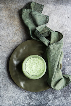 Matcha latte served on green ceramic plate