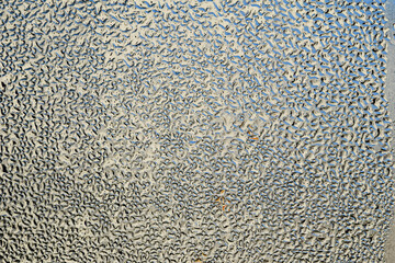 Macro image of water condensation and dripping streaks on a window pane. Household energy loss, poor insulation, and environmental impact.