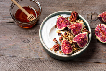 Granola bowl with figs and pecan nuts for healthy breakfast