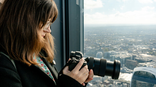 Woman capturing London view with professional camera