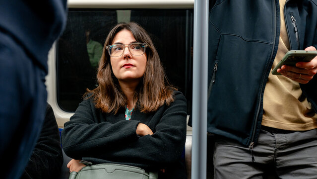 Woman on commute in a London Underground train