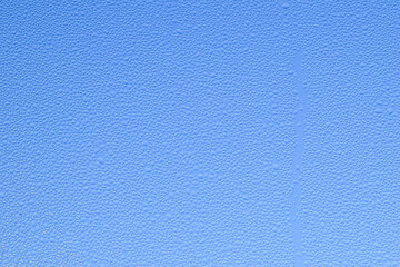 Macro image of water condensation and dripping streaks on a window pane. Household energy loss, poor insulation, and environmental impact.