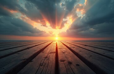 Wooden pier stretches towards horizon over calm sea at sunset. Golden sun rays break through dark clouds, creating dramatic sky scene. Empty deck provides peaceful view of ocean. Light reflections on