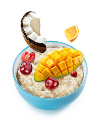 oatmeal and fruits in blue ceramic bowl isolated white background. a mockup for package design