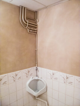 Abandoned interior with exposed plumbing pipes