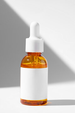 Orange serum bottle on white background