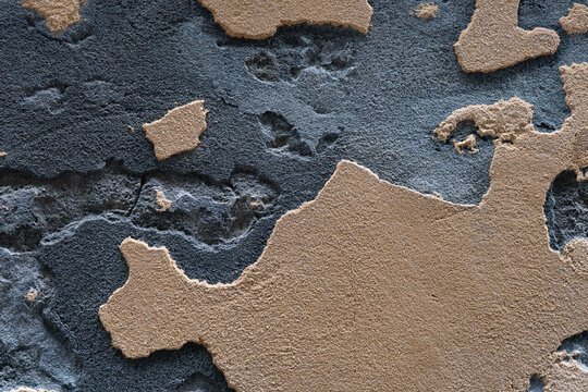 Textured surface of rough brown and gray wall material