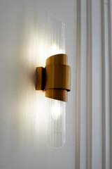 Gold sconces with a glass insert. Decorative beaucorvoy light in minimalist style,