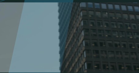 Dark-tinted office skyscraper facade displaying grid windows in downtown, geometric pattern