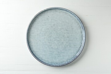 Stylish ceramic plate on white wooden table, top view