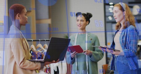 Discussing three professionals reviewing data charts in studio, with laptop measuring tape