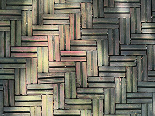 Weathered Brick Basketweave Paving Pattern: Close-up of Textured, Aged, Moss-Covered Red and Green Bricks in Woven Interlocking Floor Design.