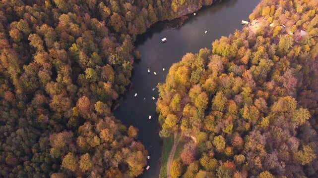 Aerial view of Lake Parz in Dilijan, Armenia during autumn. Beautiful scenic forest landscape with boats on the lake.