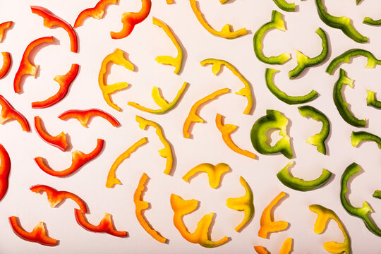 Sliced bell peppers in vibrant colors on white background