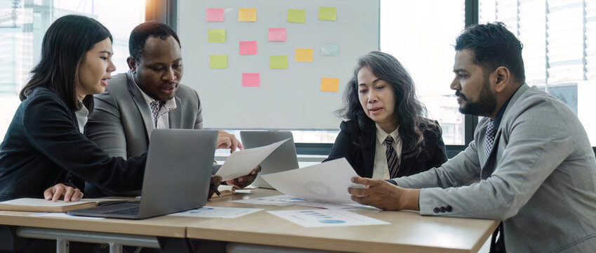 diverse business workgroup designers team with asian woman leader discuss paperwork financial report statistical data, forecasting working on common project. Brainstorm, briefing activity concept