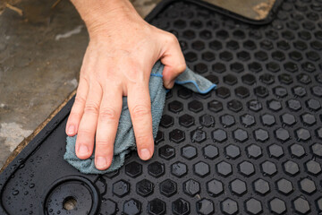 Hand washing an SUV at home with a cloth