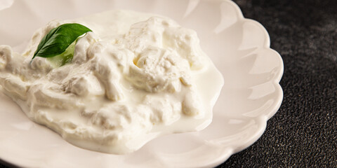 Stracciatella cheese soft young portion size Italian food natural product tasty snack fresh delicious gourmet food background on the table rustic top view copy space