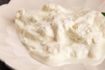 Stracciatella cheese soft young portion size Italian food natural product tasty snack fresh delicious gourmet food background on the table rustic top view copy space