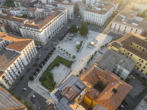 Aerial view of Piazza della Liberta bathed in the warm glow of the setting sun, surrounded by classic architecture, casting long shadows across the stone, Avellino, Campania, Italy.