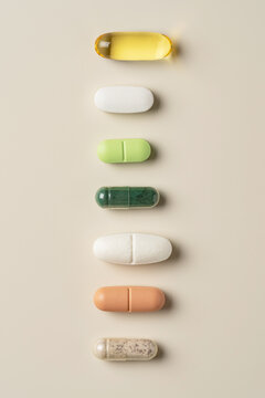 Assorted pills on beige background in top view