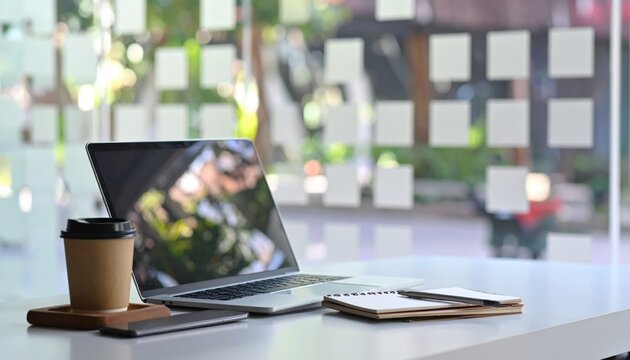Hybrid Meeting Setup &ndash; Laptop, Notepad, Coffee, Blurred Office Background 