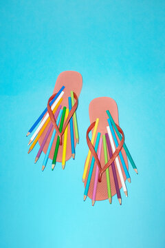 Creative summer art concept with sandals and colored pencils