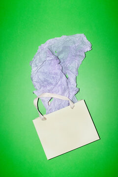 Shopping bag with decorative tissue paper on green