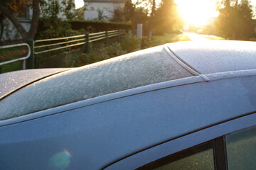 bright morning sunlight and frost on car window
