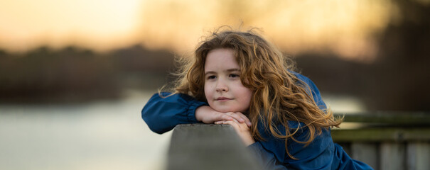 Childhood. Blonde kid dreams. Child thoughtful expression. Little thinker enjoying a carefree day. Happy kid portrait. Dreams in a child eyes. Quiet moment of childhood imagination.