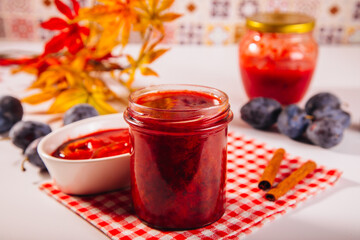 Homemade plum jam and fresh organic plums.