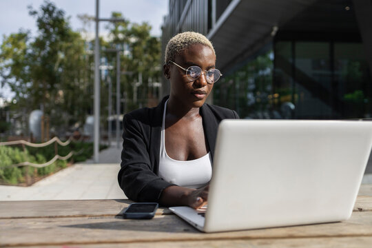 Businesswoman working on her laptop outdoors