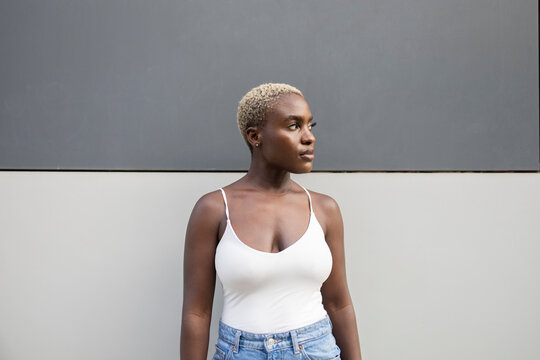 Confident businesswoman standing against modern backdrop