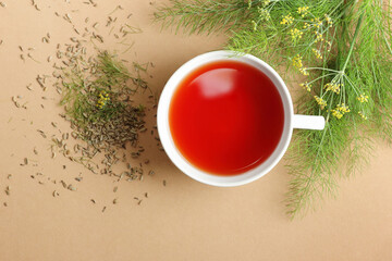 Fennel seed tea with leaves and flowers on beige background, copy space, natural medicine, antiviral treatment, immune booster concept