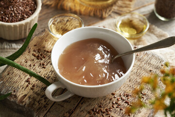 Homemade flax seed gel in a cup, aloe vera, argan oil, apple cider vinegar - ingredients for natural alternative diy shampoo