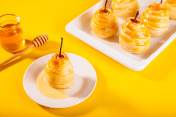Pears in puff pastry dough drizzled with honey. Healthy and organic food.