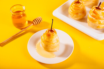Pears in puff pastry dough drizzled with honey. Healthy and organic food.