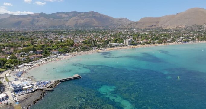 Aerial view of Mondello Beach near Palermo, Sicily, Italy. It's a beautiful bay and a popular tourist destination for Sicilian summer vacations. The sea ranges in color from blue to turquoise.