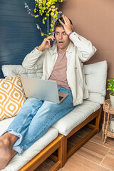 vertical Young Hispanic man reacting to bad remote work news