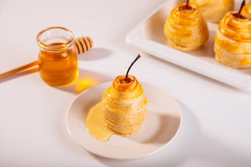 Pears in puff pastry dough drizzled with honey. Healthy and organic food.