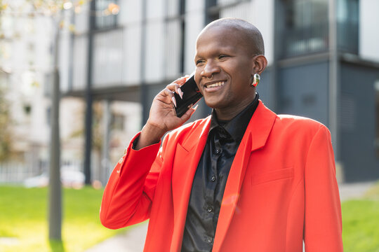 Young man in red jacket enjoying phone call