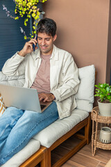 vertical Young Hispanic man teleworking from home using laptop