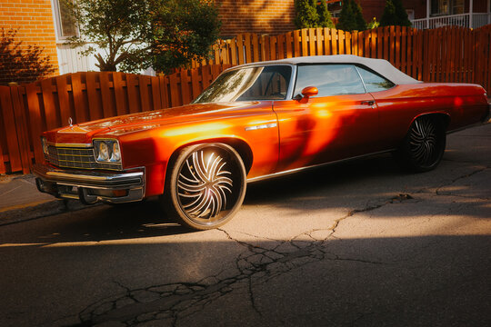 Orange convertible classic car on a sunny street