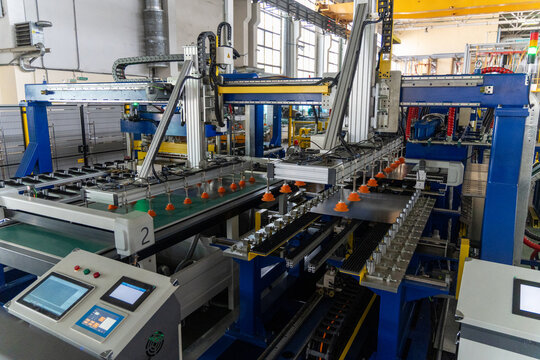 A modern automated stamping machine on a refrigerator production line