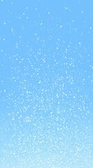 Obraz premium Light snow descends softly in a clear blue sky, creating a serene winter atmosphere filled with peace and beauty in nature