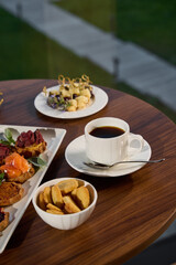 Gourmet Coffee and Snacks Perfectly Arranged on a Stylishly Set Table for Enjoyment