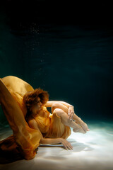 An Ethereal Underwater Portrait Featuring Flowing Yellow Fabric Captivating the Viewer