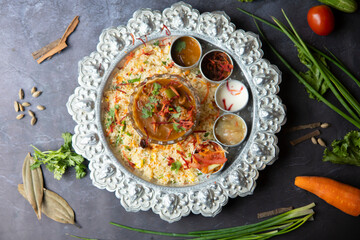 Curry with Meat and Vegetables Served Over Rice on a Silver Platter top view of bangladeshi food